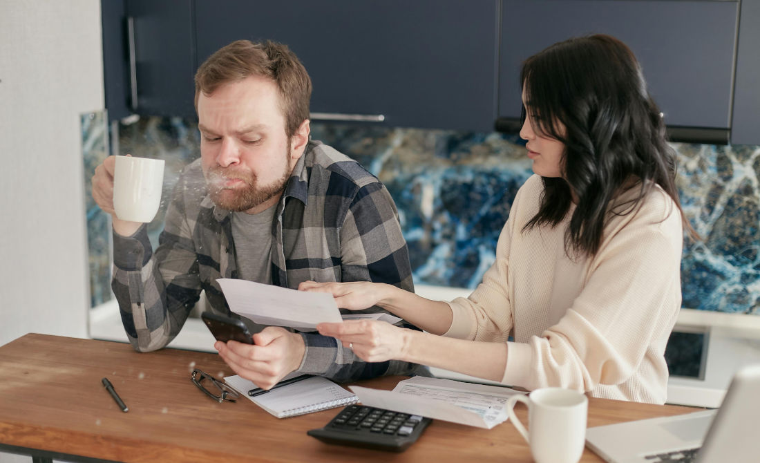 A man spits out his coffee as he discovers the debt figures