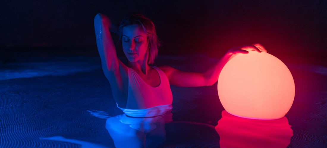 An image of a woman enjoying red light therapy in a spa setting